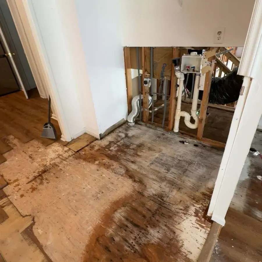Wall opened around the plumbing with the wet flooring pulled up