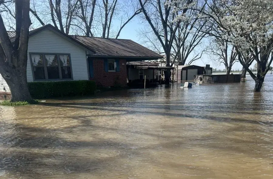 Floodwater surrounding a ranch house after a creek rose